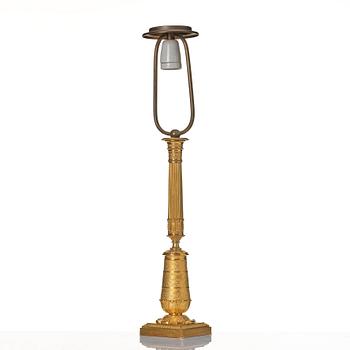 An gilded Empire table lamp.