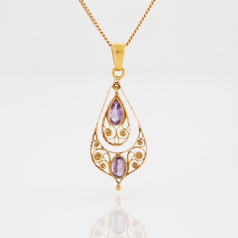 A PENDANT set with amethysts.