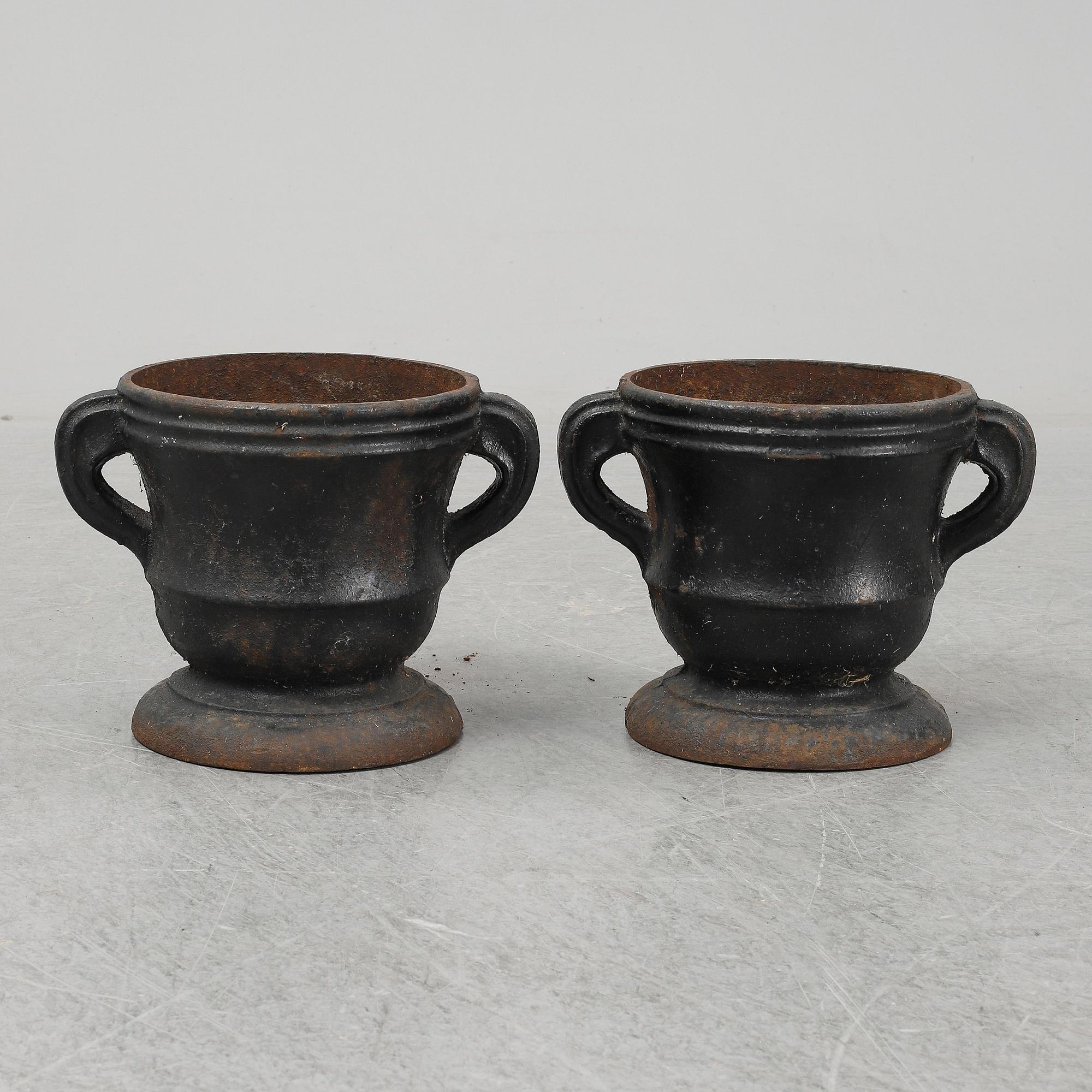 A 19th  century pair of cast iron flower pots.