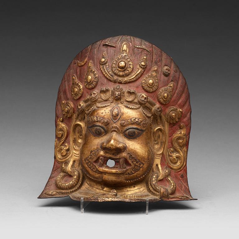 A copper alloy repousse mask, Nepal, presumably 17/18th Century.