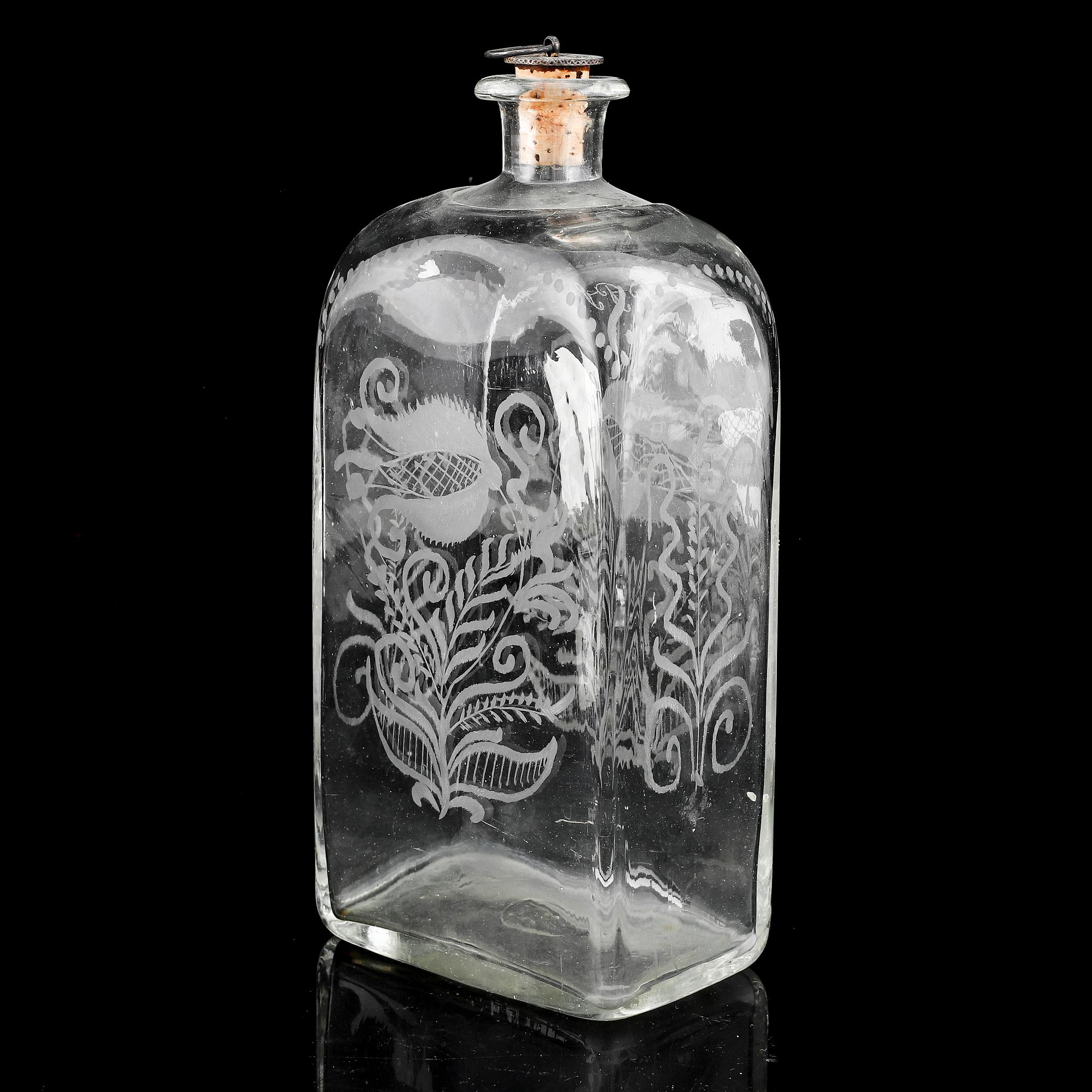 A glass bottle and three vodka glasses, 19th Century.