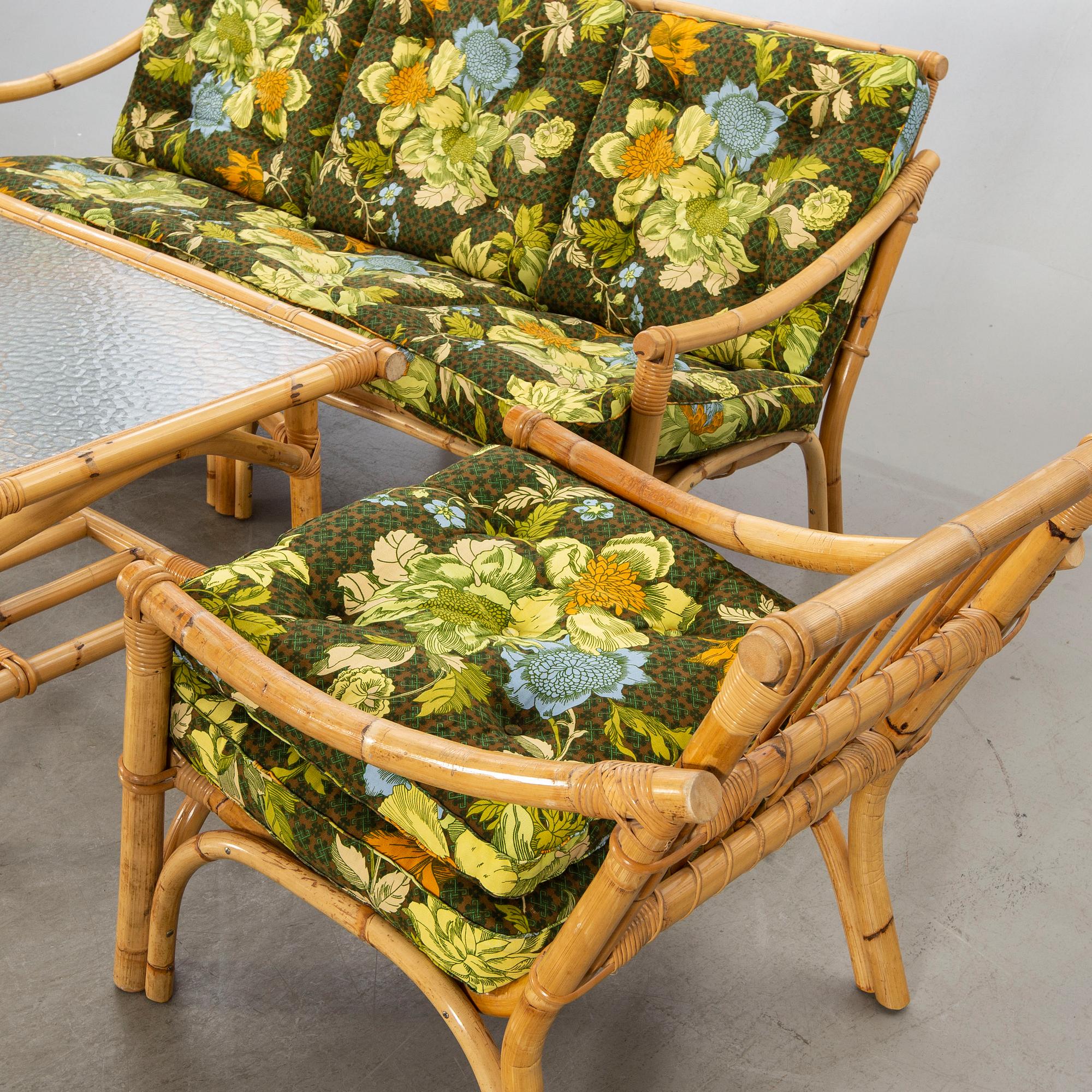 A set of ratten furniture, late 20th century; sofa, armchairs and a lounge table.