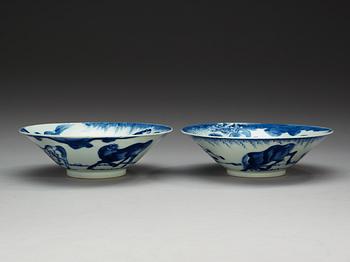 A pair of blue and white bowls with eight horses, Qing dynasty, 18th Century.