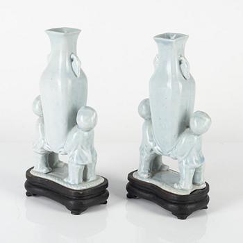A pair of Chinese pale blue boys vases, around 1900.