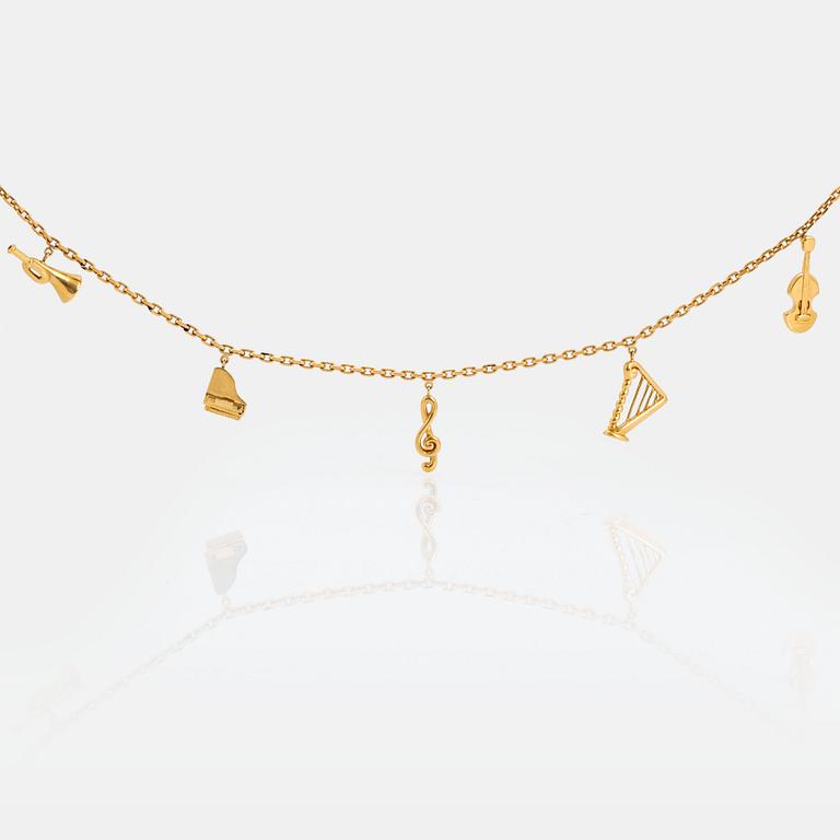 An 18K gold  Dior necklace with charms.