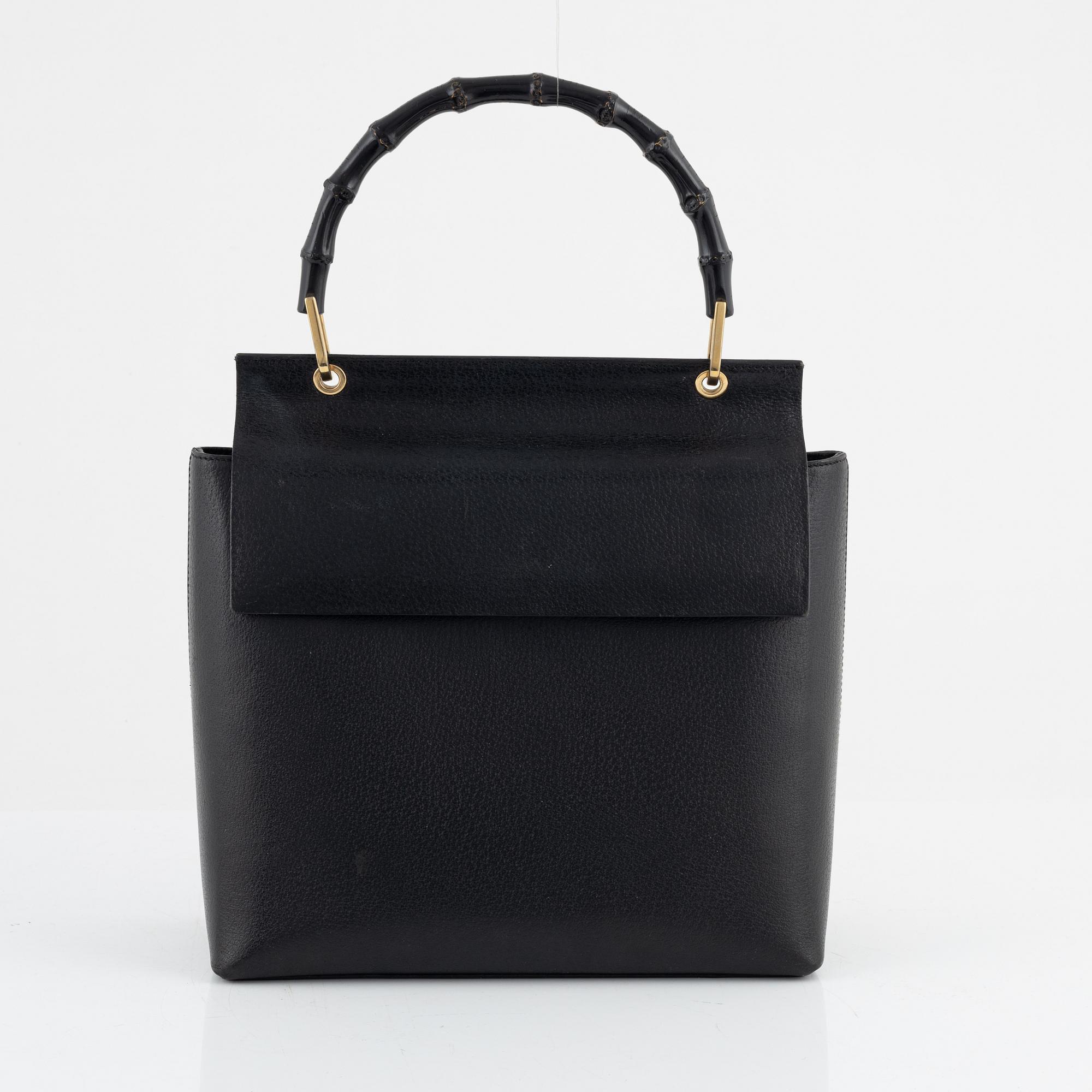 Gucci, a black leather and bamboo bag.