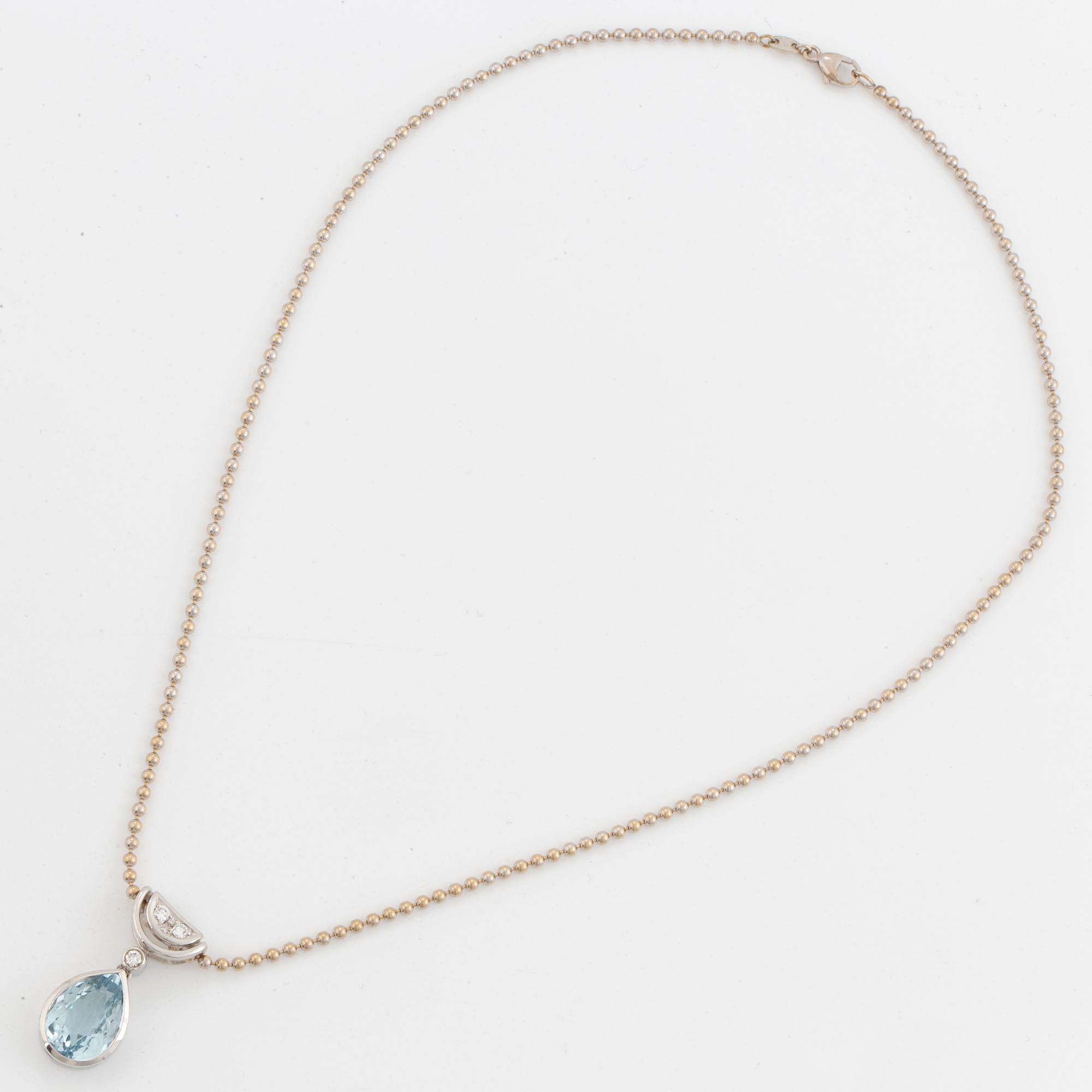 White gold chain and pendant with pearshaped topaz and brilliant-cut diamonds.