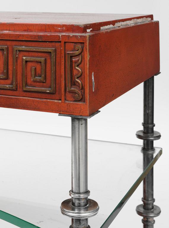 An Axel-Einar Hjorth red lacquered console table "Åbo" with silverplated brass legs, a glass shelf, Nordiska Kompaniet 1929-30.