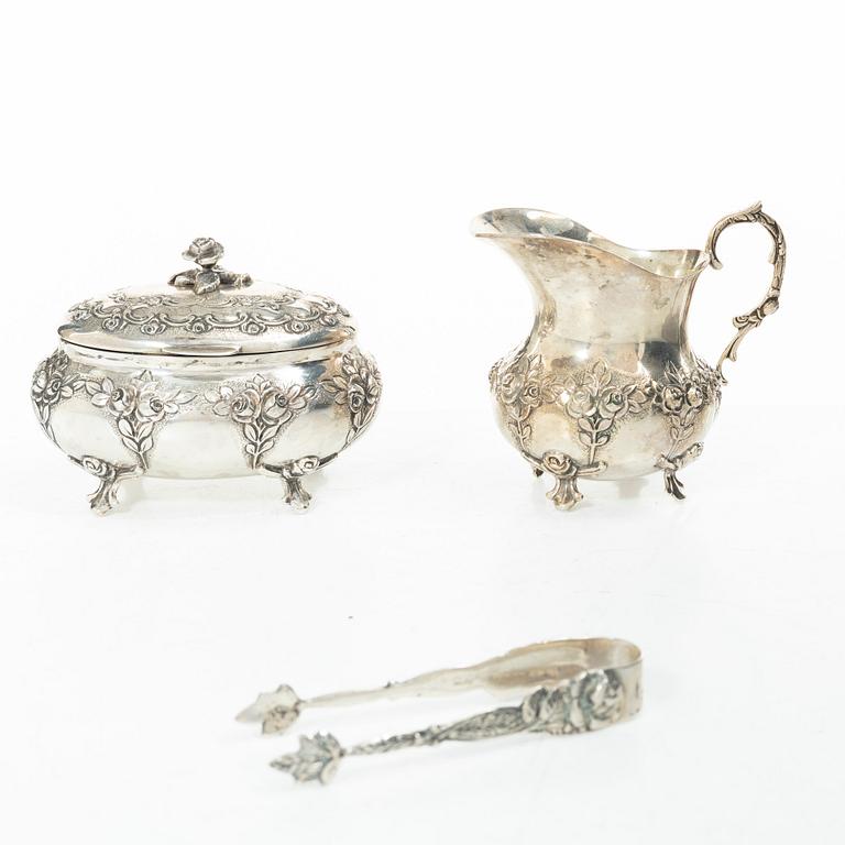 A silver sugar bowl, creamer and sugar tongs, 20th century.
