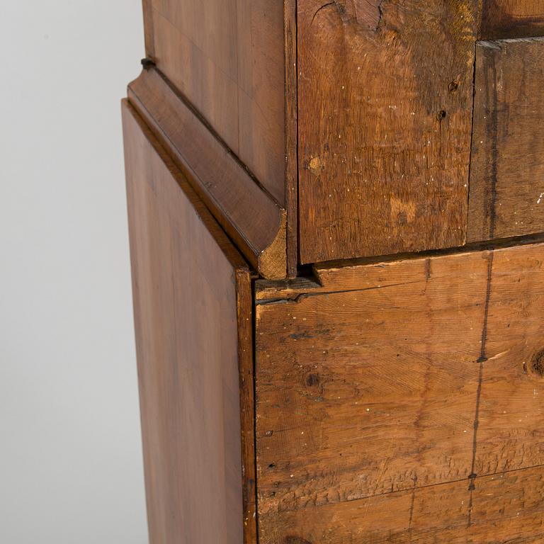 A Swedish walnut-veneered rococo cabinet in the manner of C. Linning, latter half of the 18th Century.