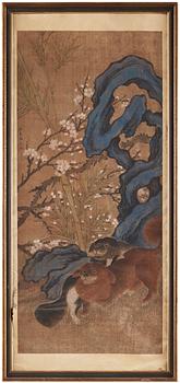 302. A painting of two playing dogs in front of a garden rock, late Qing dynasty (1644-1912).