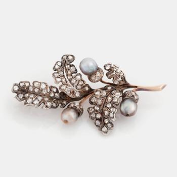 383. A silver and gold brooch set with pearls and rose-cut diamonds.