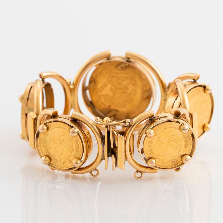 An 18K gold bracelet set with Mexican 22K gold coins.