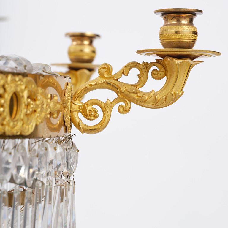 An French Empire eight-light gilt-brass and cut-glass chandelier.