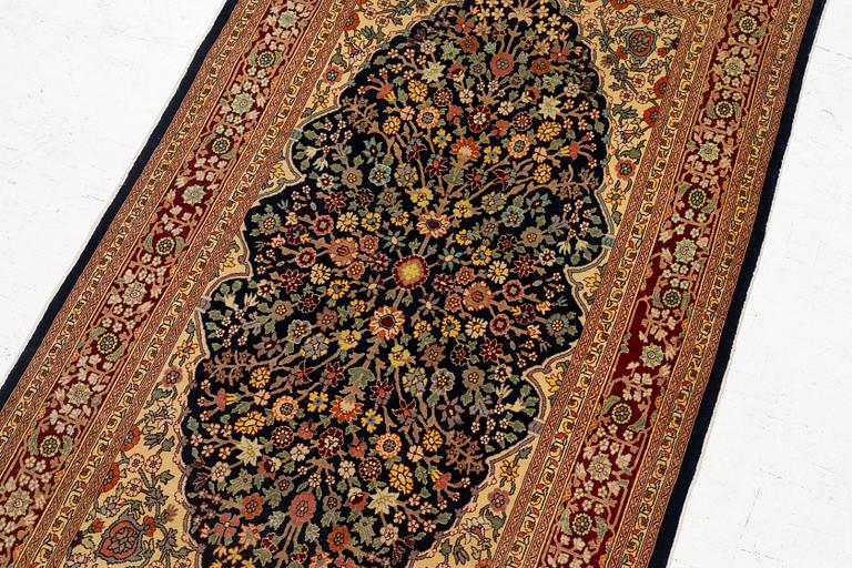 A Hereke silk rug, c. 130 x 71 cm.