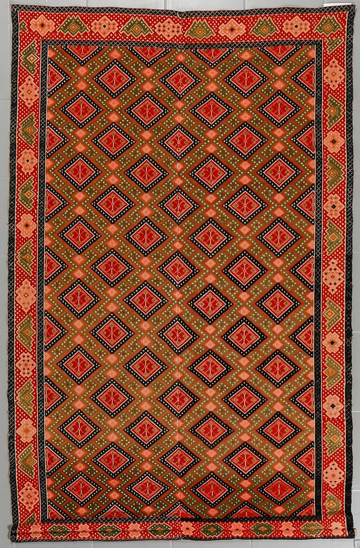A wall textile, signed, around the year 1900, 208 x 130 cm.