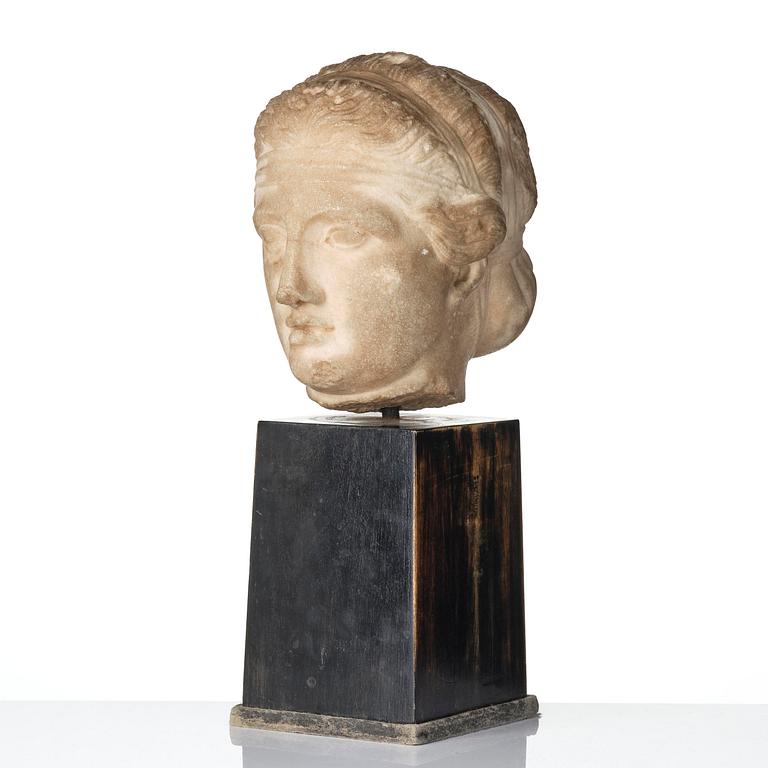 A Greek marble head of a deity wearing a Dionysiac fillet, Hellenistic style presumably 16th century.