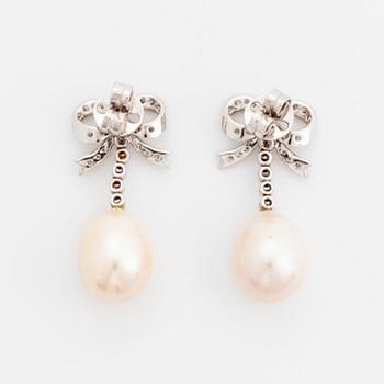 A pair of 18K gold and cultured pearl earrings set with round brilliant-cut diamonds.