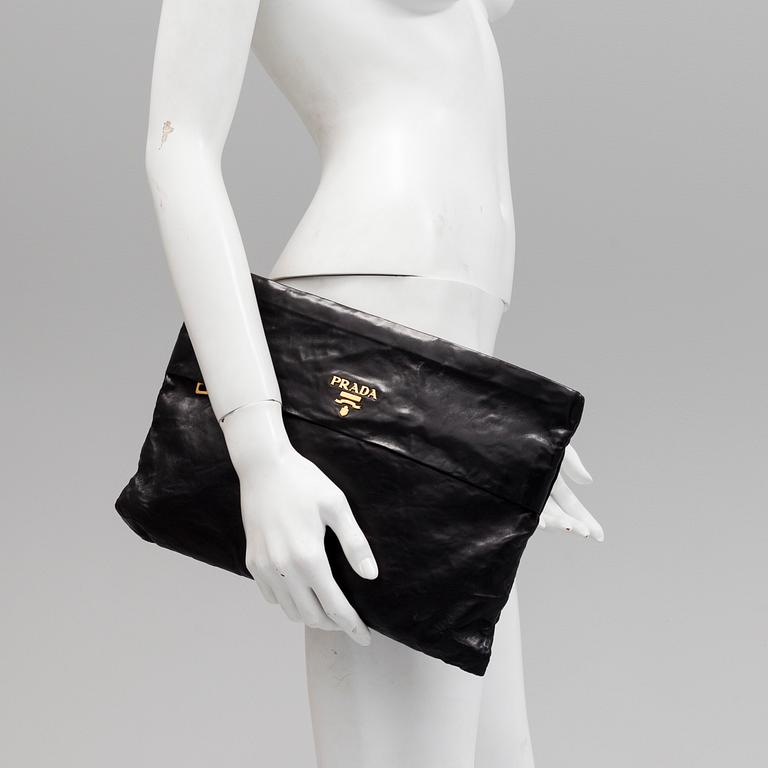 A black leather bag/clutch by Prada.