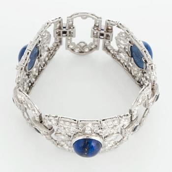 A platinum bracelet set with lapis lazuli, old-cut diamonds with a total weight of ca 10 cts and synthetic sapphires.