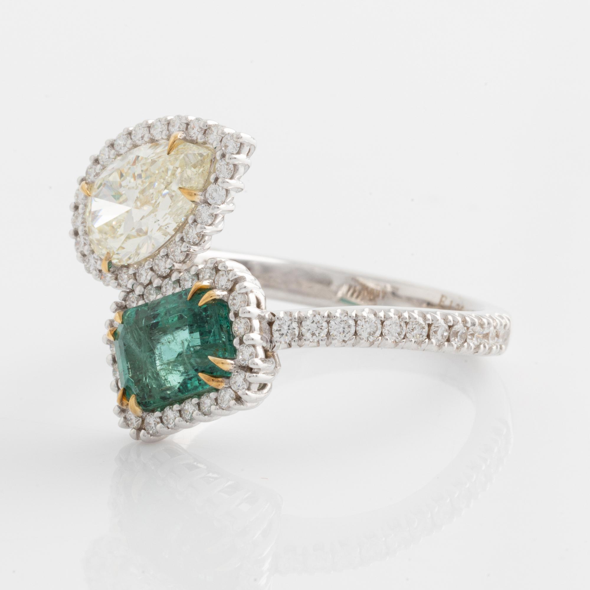 Ring with emerald-cut emerald and pear-shaped diamond, accompanying GIA diamond report.