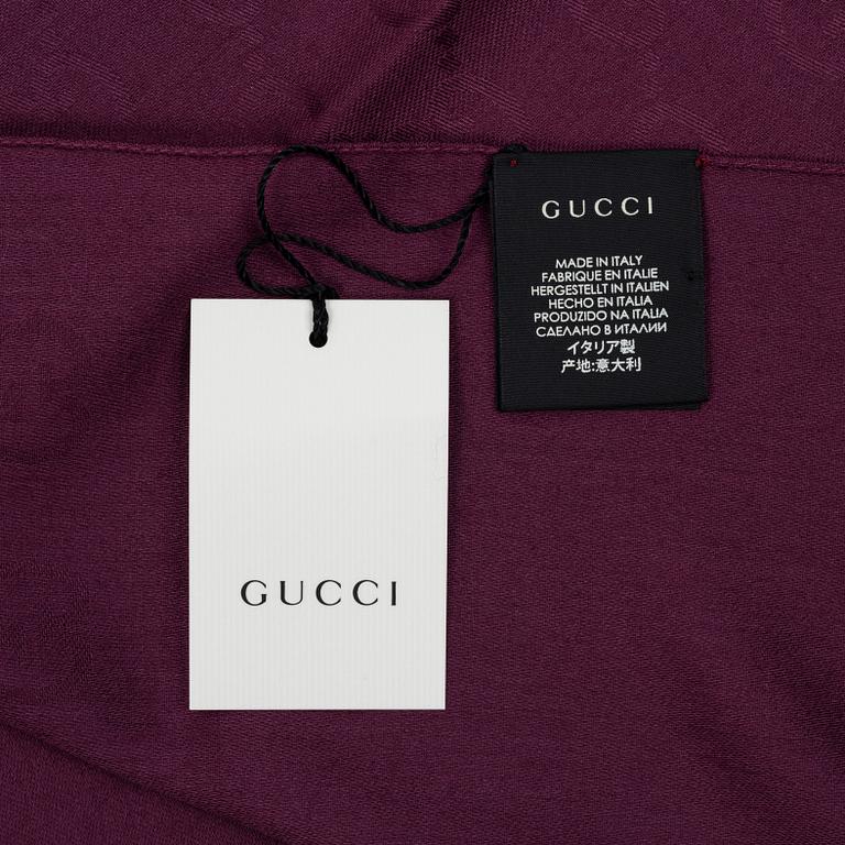 Gucci, a wool and silk mix "GG" jaquard shawl.