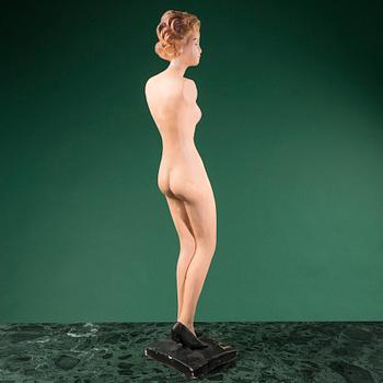 a Christian Dior mannequin doll, probably from the 1950s.