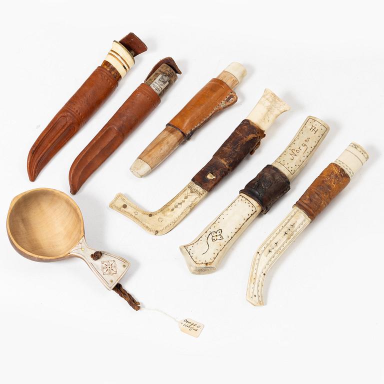 Six knives, and a cup.