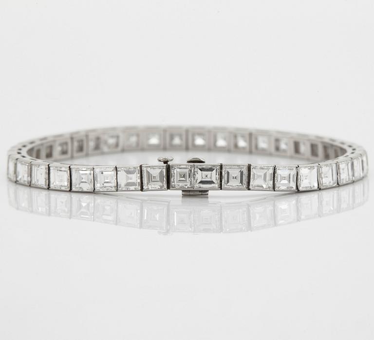 A platinum bracelet set with carré cut diamonds.