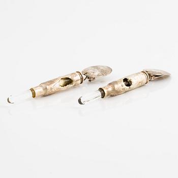 Earrings, possibly Slim Barrett.