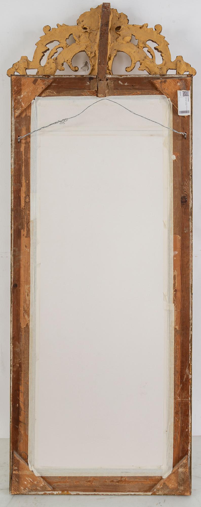 A second half of the 20th Century rococo style mirror with a console table.