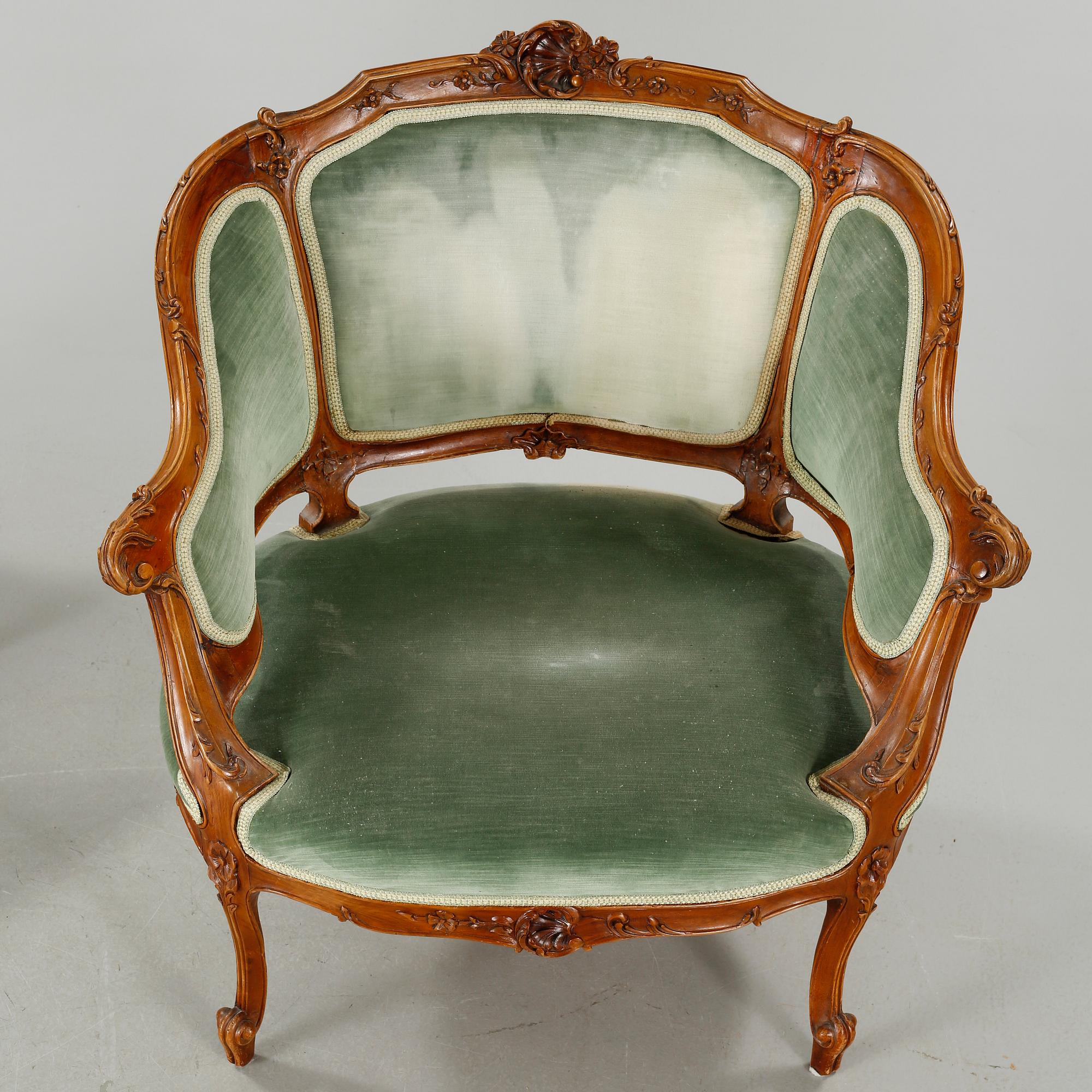 A rococo style sofa, two lounge chairs and a table, around the year 1900 and first half of the 20th century.