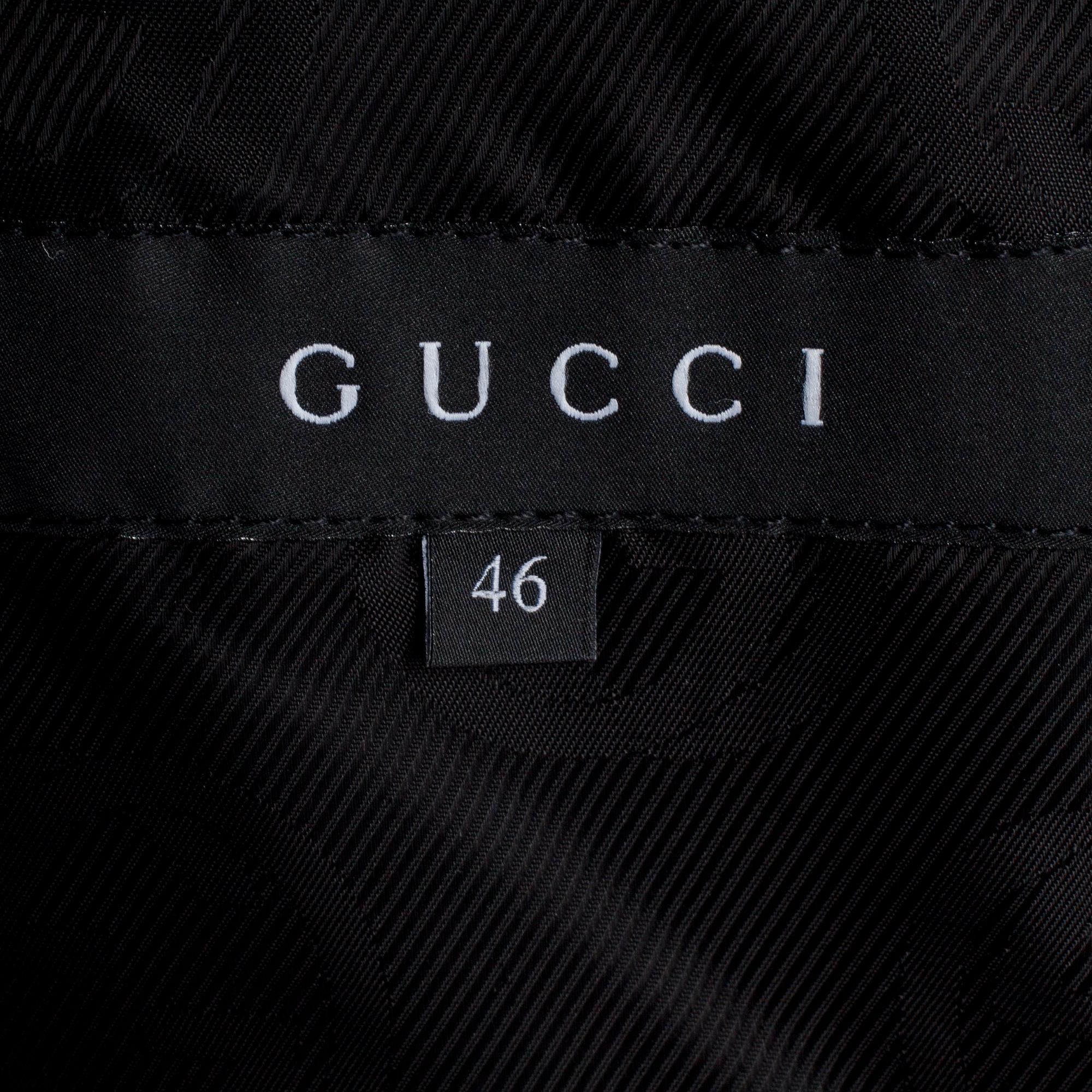 GUCCI, a dark grey wool blend jacket.