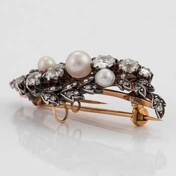 A silver and 14K gold brooch set with old- and rose-cut diamonds and pearls.