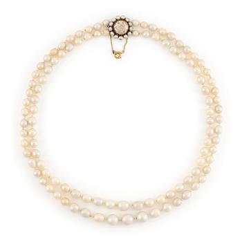 597. A two strand pearl necklace with a clasp set with a rose-cut diamond.