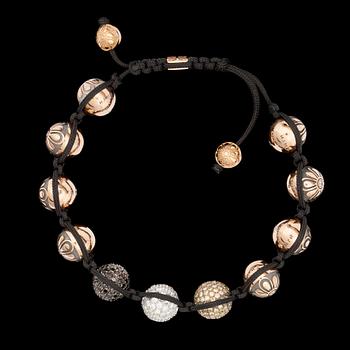 753. A bracelet in gold set with black, white and yellow diamonds.