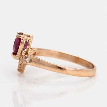 A 14K gold ring, with a heart-shaped ruby and diamonds.