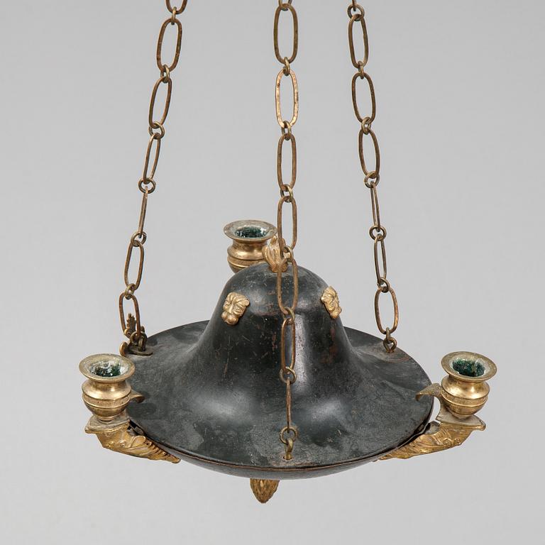 A Swedish Empire style 20th century three-light patinated brass hanging-lamp.