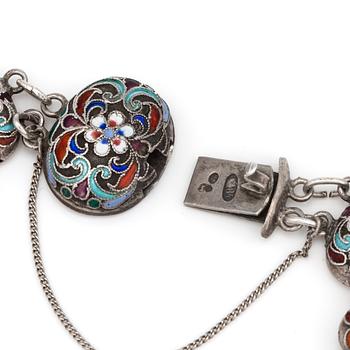 A silver bracelet with multi-coloured enamel decoration.