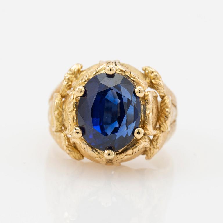 Ring, 18k gold with blue stone, possibly sapphire.