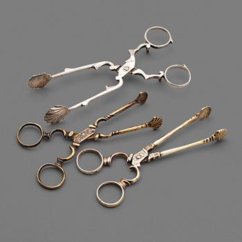 144. Three Rococo 18th century sugar-tongs.