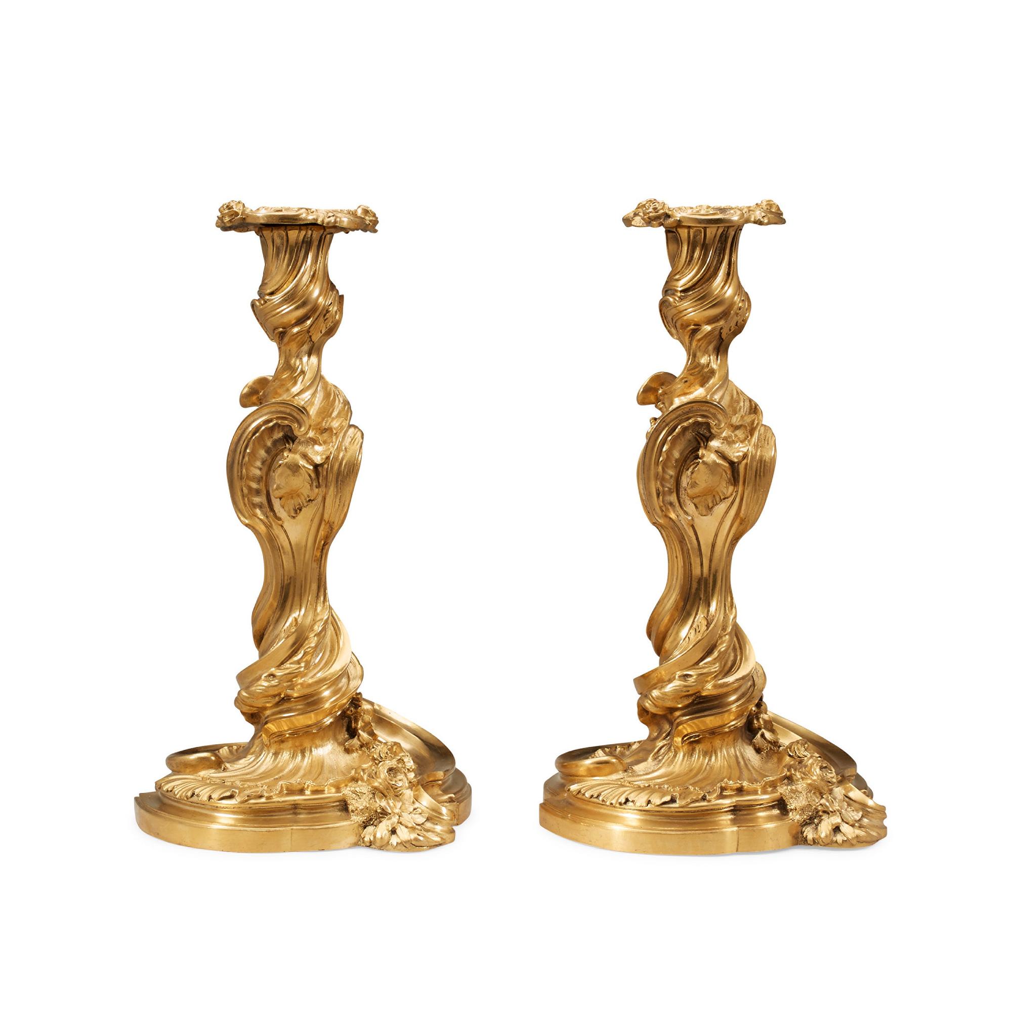 A pair of Louis XV 18th century gilt bronze candlesticks after the model by Juste-Aurèle Meissonnier.