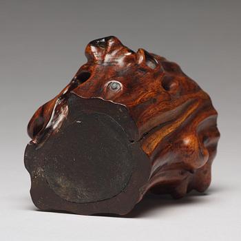 A Chinese scholars brush pot in the shape of a tree trunk.