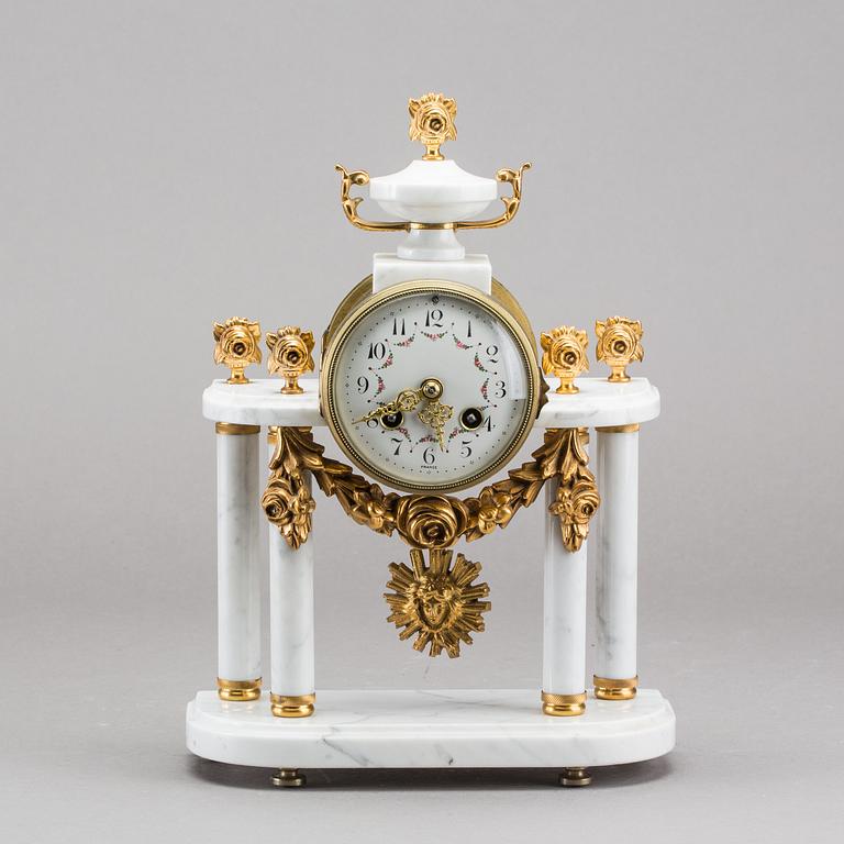 A Louis XVI-style mantle clock.