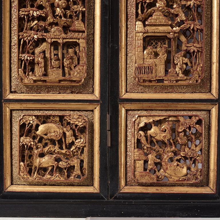 A set of four framed wooden panels, Qing dynasty, 19th Century.