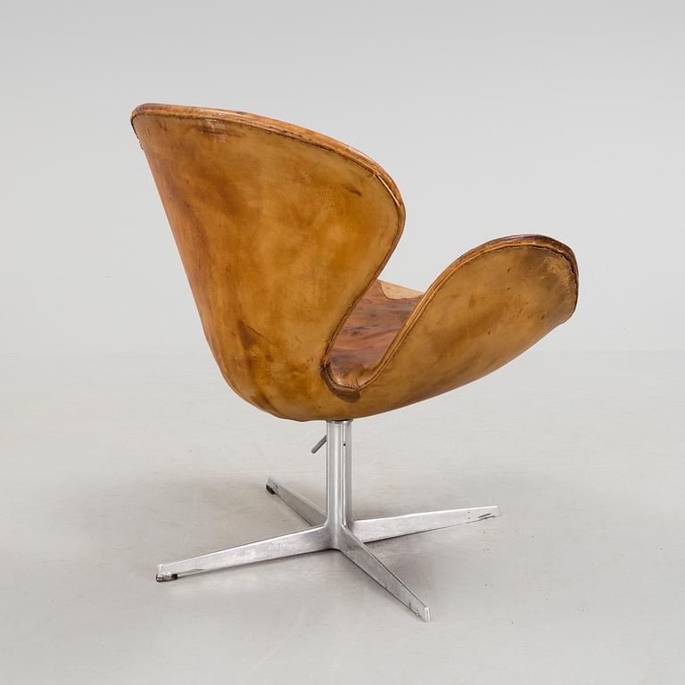 An Arne Jacobsen steel and brown leather 'Swan' chair, Fritz Hansen, Denmark 1960's.
