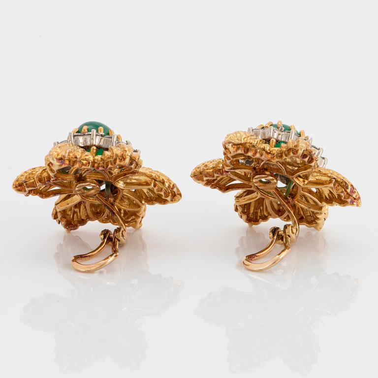 A pair of 18K gold earrings set with cabochon-cut emeralds and round brilliant-cut diamonds.