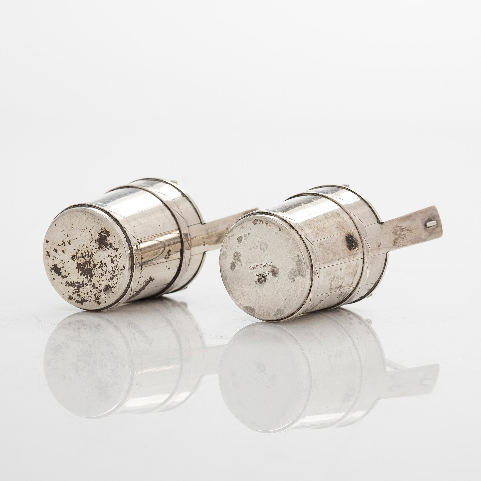 A pair of sterling silver salt- and pepper shakers , Japan, latter half of the 20th century.