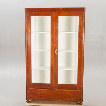 An early 1900s walnut display cabinet.