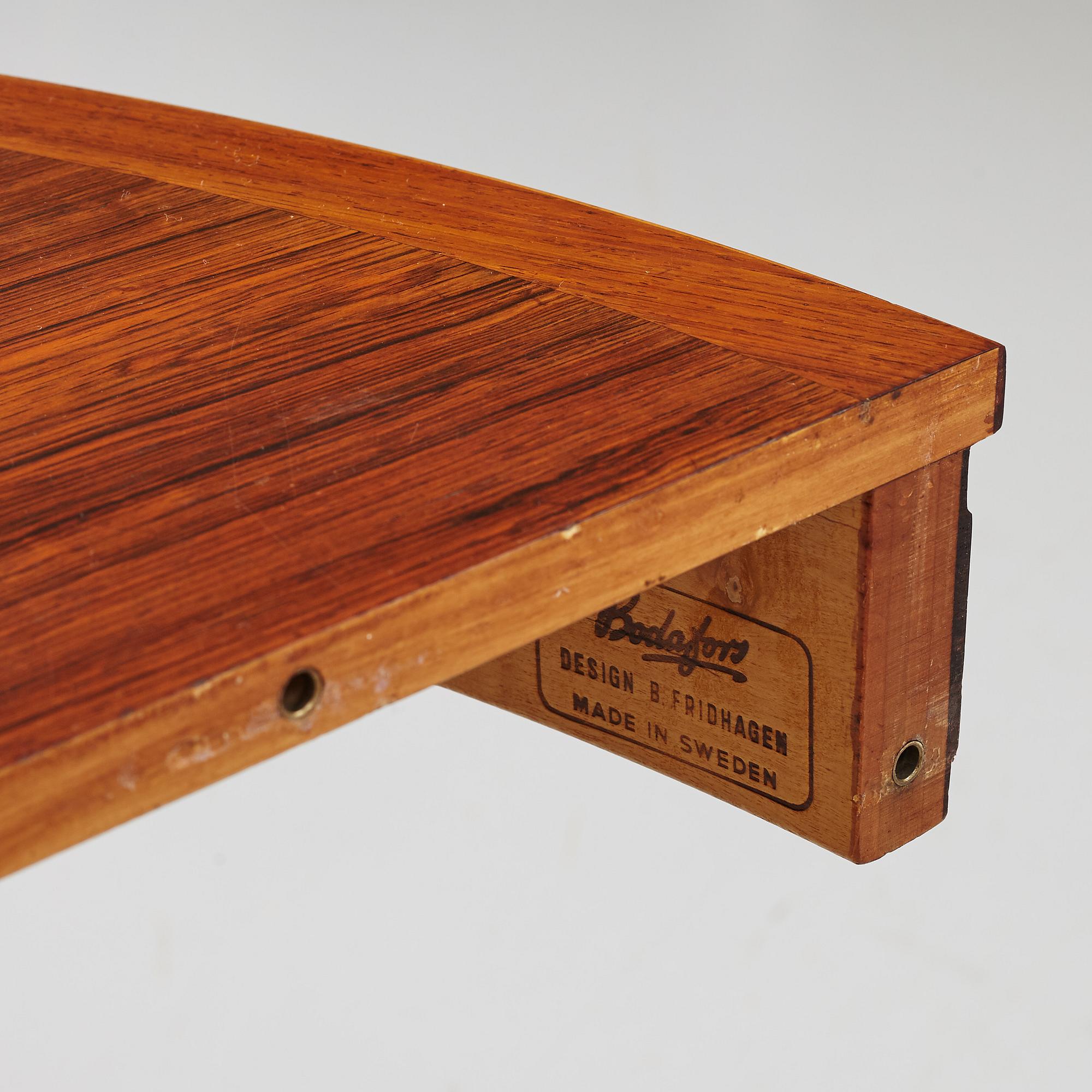 Bertil Fridhagen, a rosewood-veneered dining table with four chairs, BOdsfors, Sweden, 1960's.